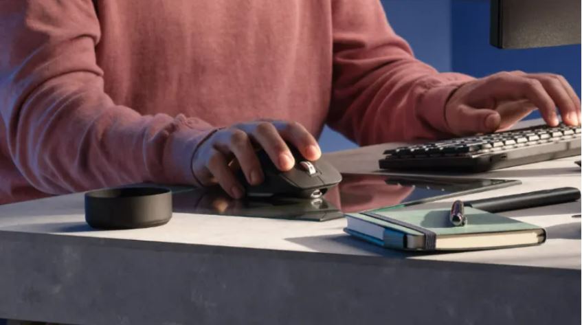 A man is using a mouse on glass